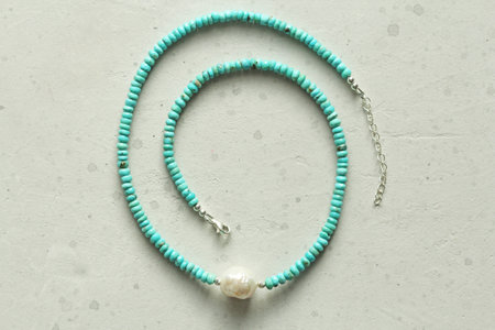 Turquoise, Kasumi pearl necklace. A short necklace made of natural turquoise, Kasumi pearl stones. Handmade jewelry made from natural stones. Modern jewelry. Natural turquoise choker with pearl.の写真素材