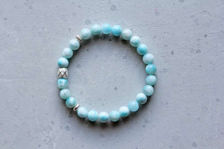 Larimar bracelet. A bracelet made of stones on a hand from natural stone Larimar. Bracelet made of natural stones. Handmade jewelry. Handmade bracelets on light modern background.の写真素材