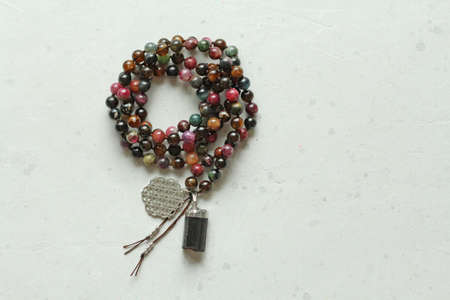 Rosary mala 108 beads from natural stones tourmaline. Author's jewelry from natural stones, Buddhism, mantra, prayer, rosary from stones for prayer and beauty. Long beads from natural stones necklace.の写真素材
