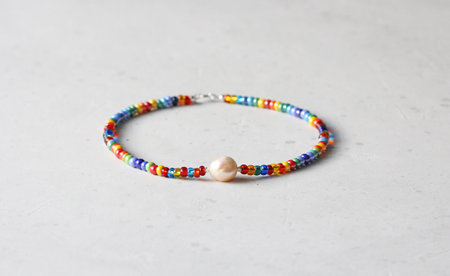 Bright multicolored Venetian glass, pearl of Kasumi necklace. A short necklace on a girl made of natural Kasumi pearl stones. Handmade jewelry made from natural stones. Modern jewelry. Rainbow.の写真素材