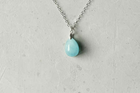 Aquamarine natural pendant, necklace. A short necklace made of Aquamarine. Handmade jewelry made from natural stones. Modern Author's jewelry. Natural blue Aquamarine pendant on silver chain.の写真素材