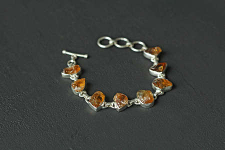 Citrine bracelet. Bracelet made of stones on hand from natural stone Citrine. Bracelet made of natural stones. Handmade jewelry. Handmade bracelets on light modern background. Stylish stone jewelry.の写真素材
