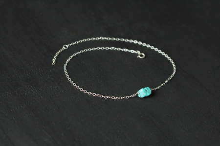 Turquoise nugget on silver chain necklace. A short necklace on a girl made of natural stones Turquoise nugget. Handmade jewelry made from natural stones. Modern jewelry. Choker around the neck.の写真素材