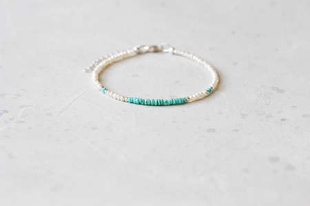 Beautiful asymmetrical designer bracelet made of natural stones and silver. Aquamarine, rock crystal, cacholong, larimar, moonstone. Handmade jewelry made from natural stones.の写真素材