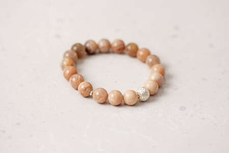 Chrome diopside bracelet. A bracelet made of stones on a hand from natural stone Chrome diopside. Bracelet made of natural stones. Handmade jewelry. Handmade bracelets on light modern background.の写真素材