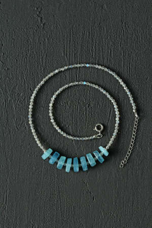 Chrome diopside bracelet. A bracelet made of stones on a hand from natural stone Chrome diopside. Bracelet made of natural stones. Handmade jewelry. Handmade bracelets on light modern background.の写真素材