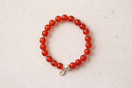 Chrome diopside bracelet. A bracelet made of stones on a hand from natural stone Chrome diopside. Bracelet made of natural stones. Handmade jewelry. Handmade bracelets on light modern background.の写真素材