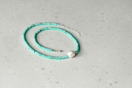 Chrome diopside bracelet. A bracelet made of stones on a hand from natural stone Chrome diopside. Bracelet made of natural stones. Handmade jewelry. Handmade bracelets on light modern background.の写真素材