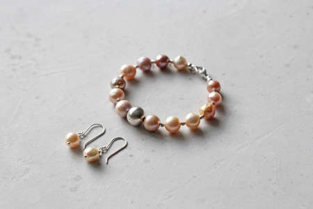 Chrome diopside bracelet. A bracelet made of stones on a hand from natural stone Chrome diopside. Bracelet made of natural stones. Handmade jewelry. Handmade bracelets on light modern background.の写真素材