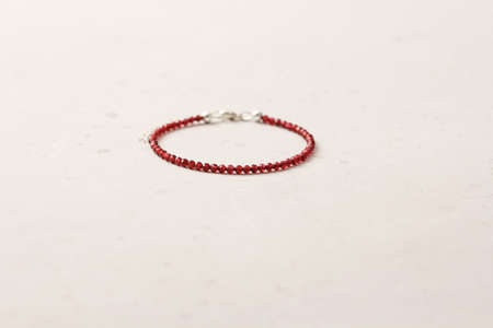 Chrome diopside bracelet. A bracelet made of stones on a hand from natural stone Chrome diopside. Bracelet made of natural stones. Handmade jewelry. Handmade bracelets on light modern background.の写真素材