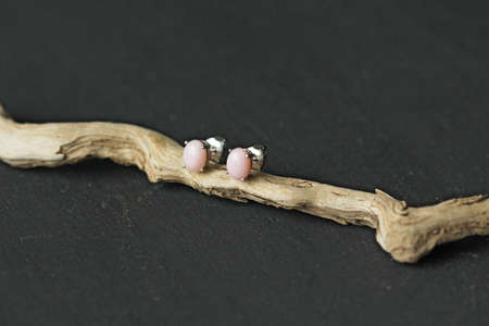 Bright delicate multi-colored tourmaline, moonstone bracelet rests on black modern concrete background. Bracelet made of stones on hand. Handmade bracelets on black modern background. LGBT bracelet.の写真素材