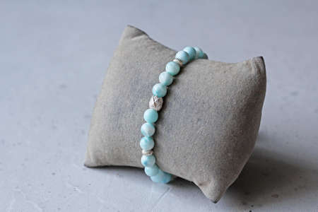 Bright delicate multi-colored tourmaline, moonstone bracelet rests on black modern concrete background. Bracelet made of stones on hand. Handmade bracelets on black modern background. LGBT bracelet.の写真素材