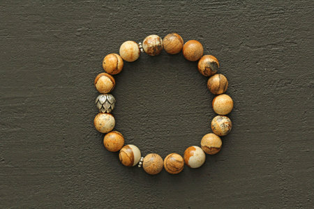 Bright multicolored bracelet. Ruby, coral, carnelian, citrine, emerald, apatite, amazonite, turquoise, lapis lazuli, tanzanite, black spinel. Handmade jewelry bracelets on light modern background.の写真素材