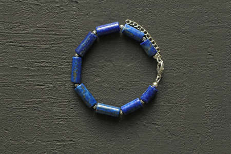 Bright multicolored bracelet. Ruby, coral, carnelian, citrine, emerald, apatite, amazonite, turquoise, lapis lazuli, tanzanite, black spinel. Handmade jewelry bracelets on light modern background.の写真素材