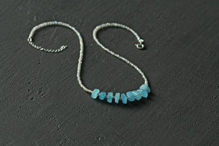 Bright multicolored bracelet. Ruby, coral, carnelian, citrine, emerald, apatite, amazonite, turquoise, lapis lazuli, tanzanite, black spinel. Handmade jewelry bracelets on light modern background.の写真素材