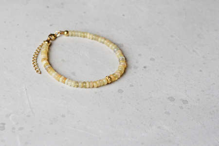 Bright multicolored bracelet. Ruby, coral, carnelian, citrine, emerald, apatite, amazonite, turquoise, lapis lazuli, tanzanite, black spinel. Handmade jewelry bracelets on light modern background.の写真素材