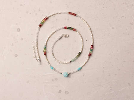 Pearls, natural stones tourmaline necklace. Handmade jewelry Short necklace for girl made of natural stones. Delicate fine jewelry of necklace made of stones, pearls. Choker around the neck.の写真素材