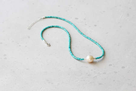 Turquoise, Kasumi pearl necklace. A short necklace made of natural turquoise, Kasumi pearl stones. Handmade jewelry made from natural stones. Modern jewelry. Natural turquoise choker with pearl.の写真素材