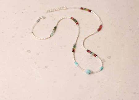 Pearls, natural stones tourmaline necklace. Handmade jewelry Short necklace for girl made of natural stones. Delicate fine jewelry of necklace made of stones, pearls. Choker around the neck.の写真素材