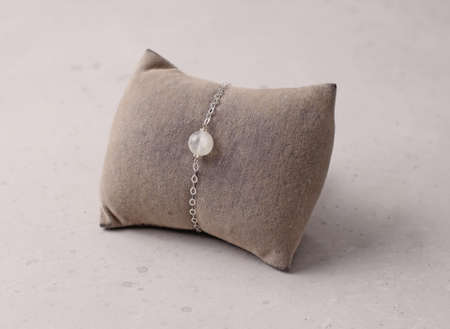 Moonstone, adularia bracelet. Bracelet made of stones on hand from natural stone Moonstone. Bracelet made of natural stones. Handmade jewelry bracelets on light modern background.の写真素材