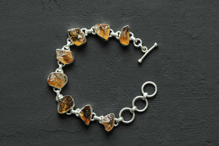 Citrine bracelet. Bracelet made of stones on hand from natural stone Citrine. Bracelet made of natural stones. Handmade jewelry. Handmade bracelets on light modern background. Stylish stone jewelry.の写真素材