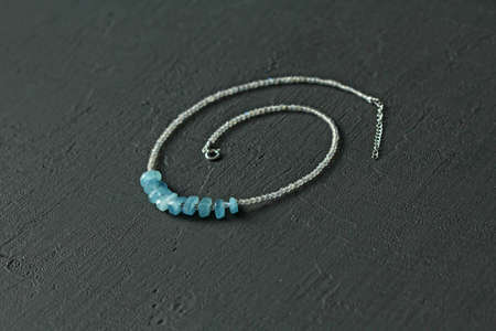 Aquamarine, labrador necklace. Short necklace made of natural Aquamarine, labrador stones. Handmade jewelry made from stones. Modern Natural Aquamarine, labrador choker on black modern background.の写真素材