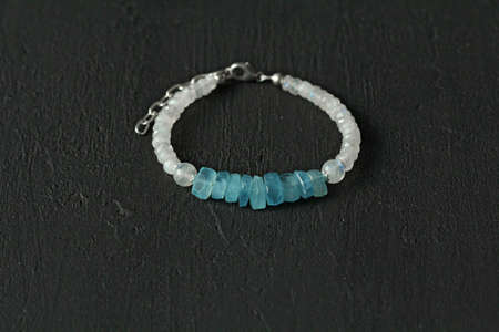 Handmade jewelry Bracelet in aquamarine and moonstone, set against a modern black background. Beautiful designer bracelet made of natural stones and silver. Aquamarine, moonstone.の写真素材