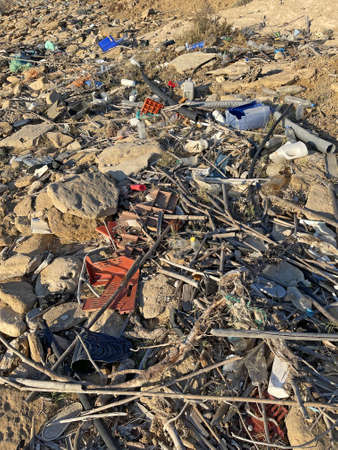 A lot of plastic, garbage and waste lies on the seashore and on the beach. Environmental disaster in nature. Environmental pollution in North Cyprus.の写真素材