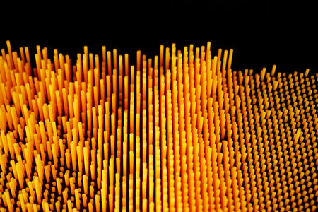 abstract background of yellow and orange stripes on a black background.の写真素材