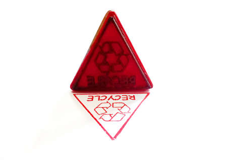 Rubble stamp and red recycle symbol stamp on a white background.