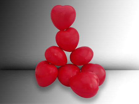 A pile of red hearts isolated on gradient black and white background with a clipping path. Concept of solidarity of teamwork for success.の写真素材