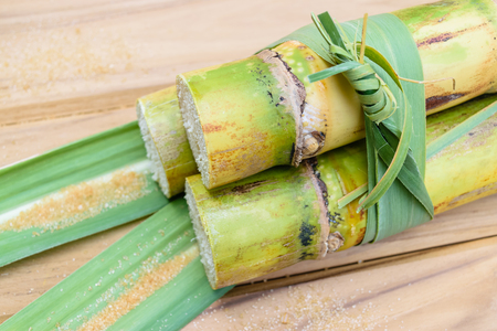 brown sugar and sugarcane on wooden tableの写真素材