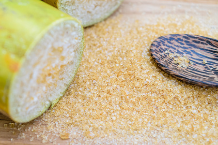 brown sugar and sugarcane on wooden tableの写真素材