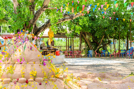 Prayer flags , pagoda and flower on sand in Songkran day festival , Thailand.の写真素材