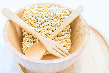 Instant noodle in a bowl wooden isolated on white backgroundの写真素材