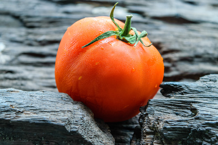fresh red tomato on old wooden backgroundの写真素材