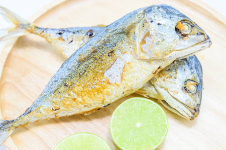 Fried mackerel fish on wood plate,Thai food.の写真素材