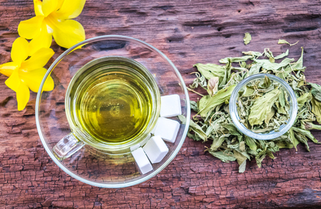 Stevia leaves with a cup stevia infusion on old wooden backgroundの写真素材