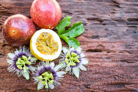 Red passion fruit on an old wood backgroundの写真素材