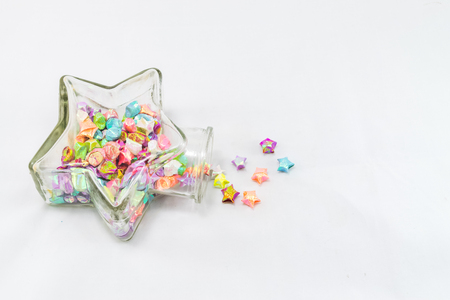 paper stars in glass jar isolated on white background.の写真素材