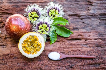 Red passion fruit on an old wood backgroundの写真素材