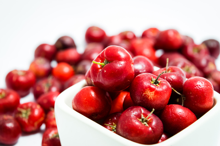 Barbados cherry, Ripe thai cherry in white square cup on white backgroundの写真素材