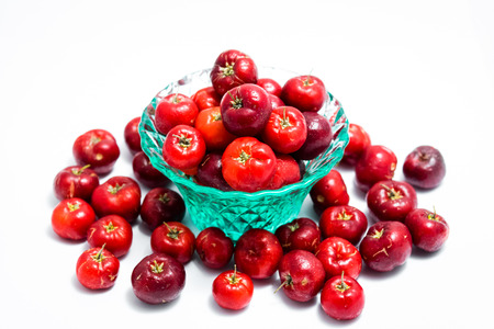 Barbados cherry in a glass isolated on white backgroundの写真素材