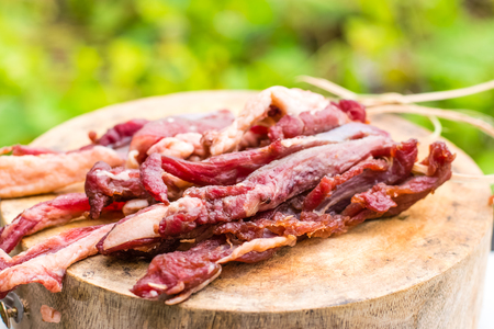 Dried meat on wooden row in Thailandの写真素材