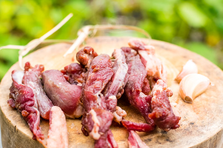 Dried meat on wooden row in Thailandの写真素材