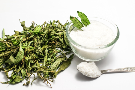 Dry stevia leaves and stevia powder in a glassの写真素材