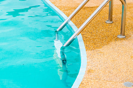 Grab bars ladder in the swimming pool, outdoorの写真素材
