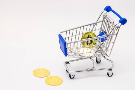 Bitcoin in mini Shopping Cart Isolated on White Backgroundの写真素材