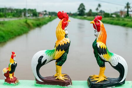 Thai chicken statue lined up on the bridgeの写真素材