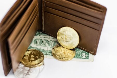 Bitcoin and leather wallet with one dollar bill isolated on white background.